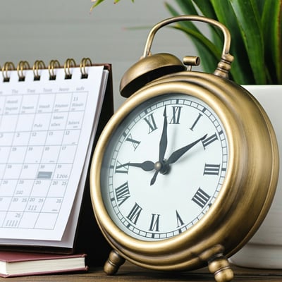 A clock and a calendar symbolizing time management